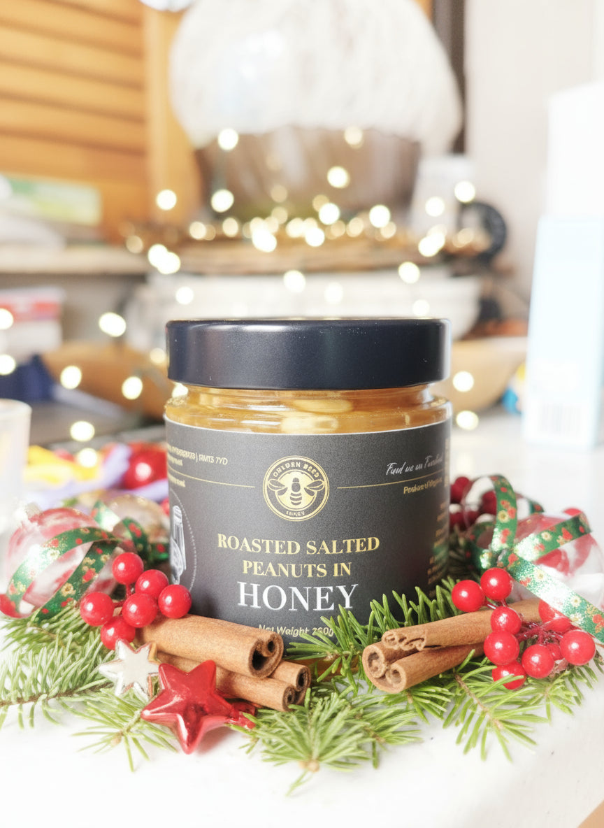 Jar of roasted salted peanuts in honey on a kitchen counter