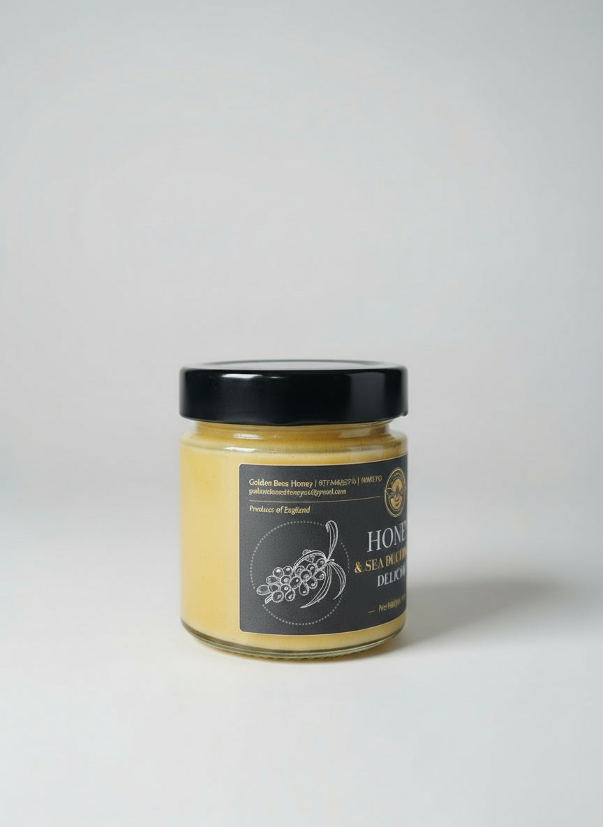 Jar of honey with a black lid on a surface, blurred background