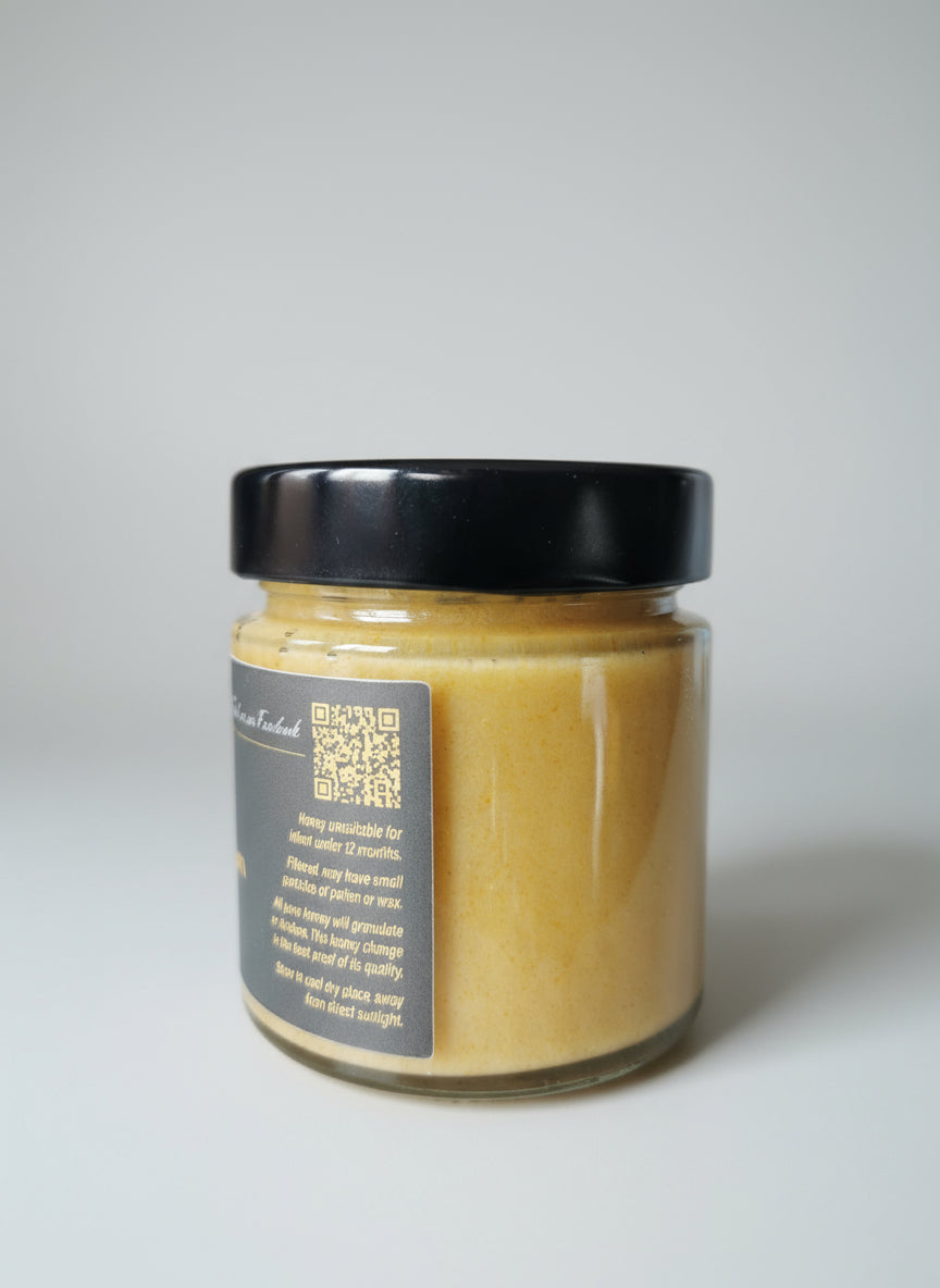 Jar of honey with a black lid on a surface